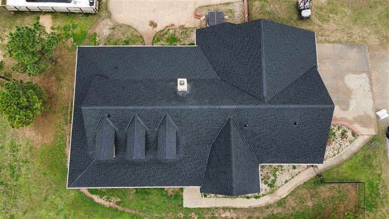 Aerial view of completed Owens Corning Duration Storm roof replacement with full hip and valley geometry, chimney flashing, and ridge ventilation, South 4160 Road, Claremore, OK - Aces Roofing and Exterior Solutions