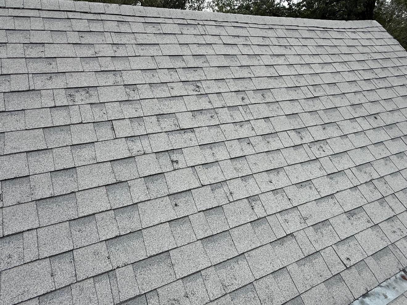 Hail-damaged roof in Collinsville Oklahoma showing granule loss and shingle damage repaired by Aces Roofing and Exterior Solutions